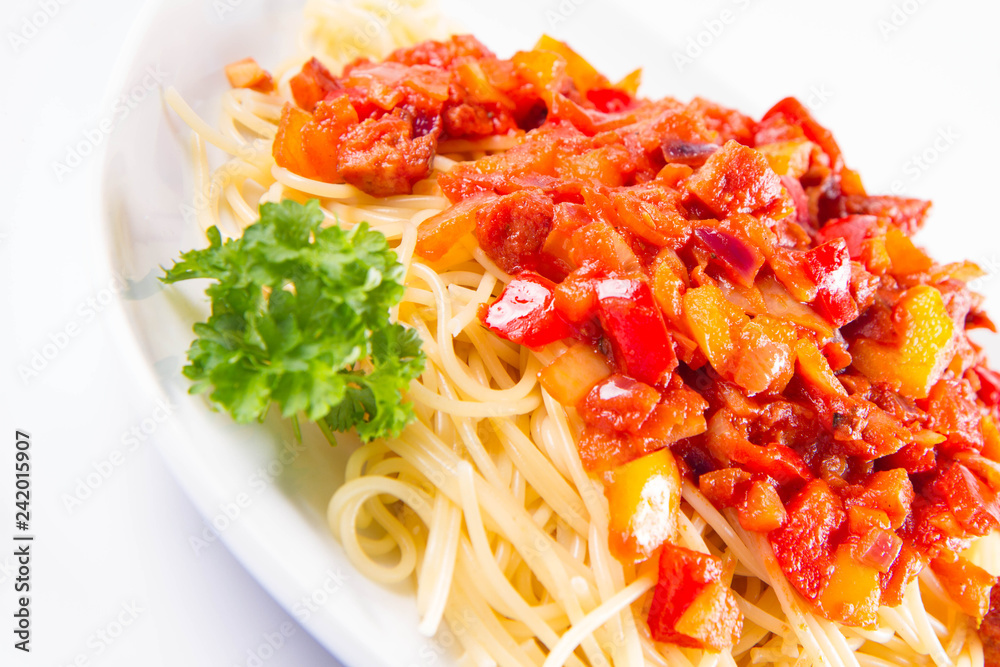 Spaghetti with sauce decorated with fresh parsley on a plate on a white background Spaghetti with sauce decorated with fresh parsley on a plate on a white background