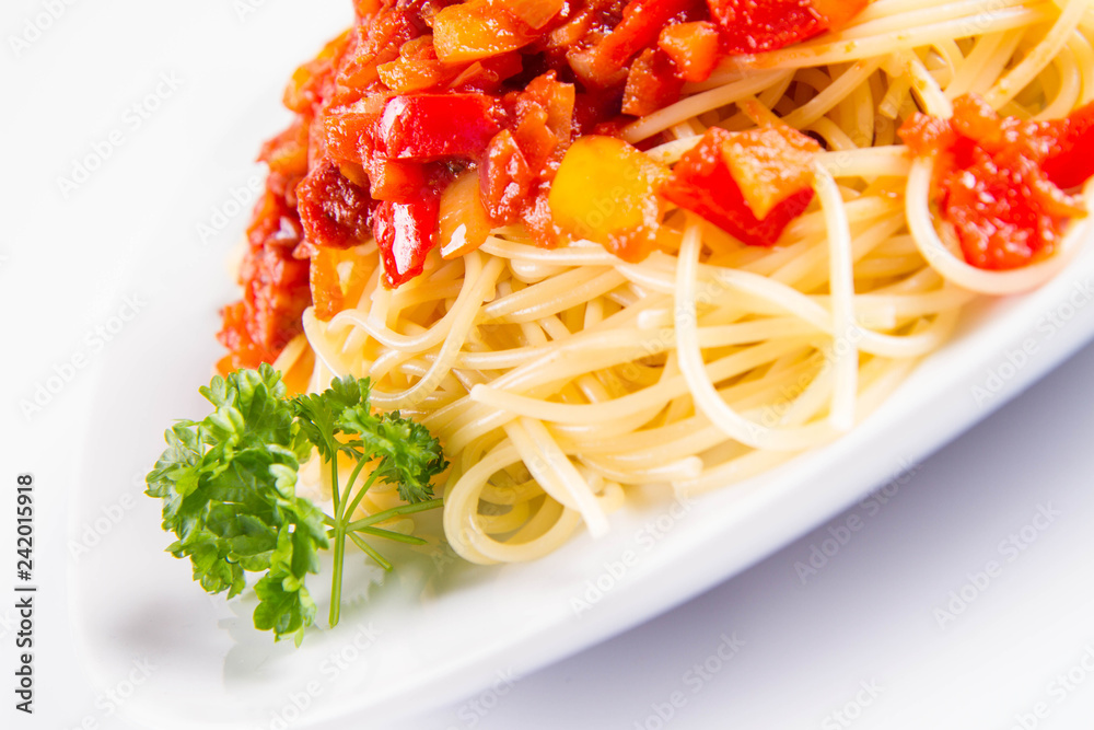 Spaghetti with sauce decorated with fresh parsley on a plate on a white background Spaghetti with sauce decorated with fresh parsley on a plate on a white background