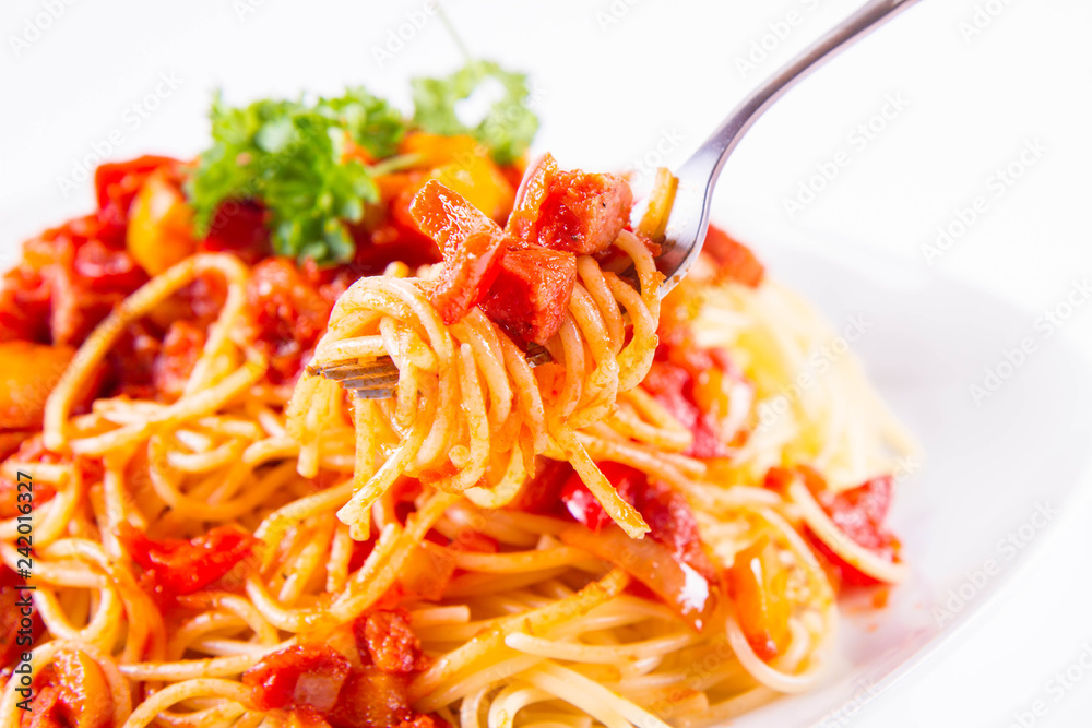 Spaghetti with sauce decorated with parsley eaten with a fork on a white background Spaghetti with sauce decorated with parsley eaten with a fork on a white background
