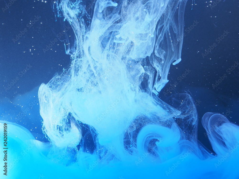 Fototapeta premium Blue paint is mixed with water. The dissolution of ink in water.