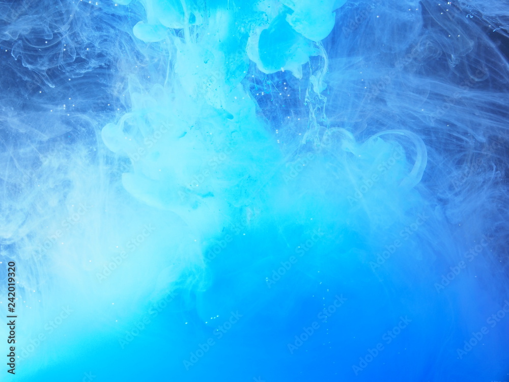 Blue paint is mixed with water. The dissolution of ink in water. Blue paint is mixed with water. The dissolution of ink in water.