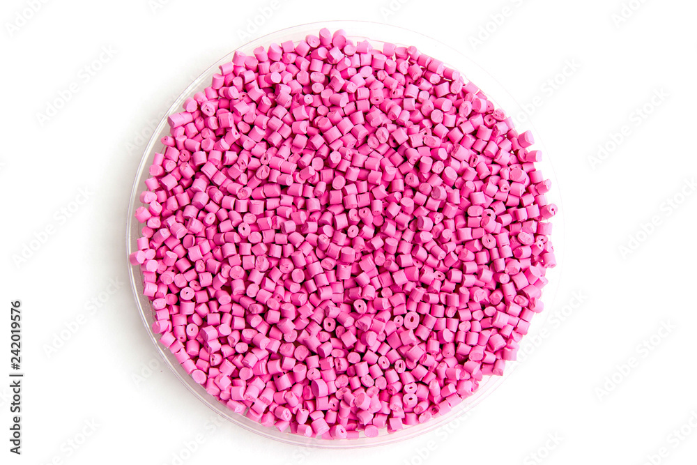 The plastic granules. Dye for polypropylene, polystyrene granules into a measuring container The plastic granules. Dye for polypropylene, polystyrene granules into a measuring container