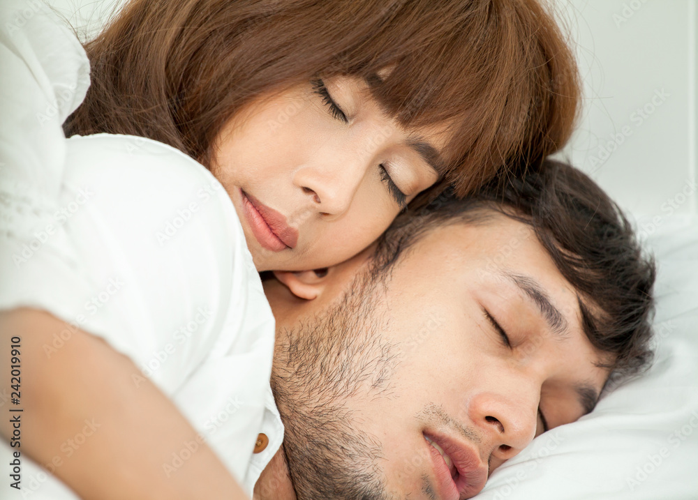 close up of Young asian happy couple in love lying together in bed . sleep . relax .Romantic close up of Young asian happy couple in love lying together in bed . sleep . relax .Romantic