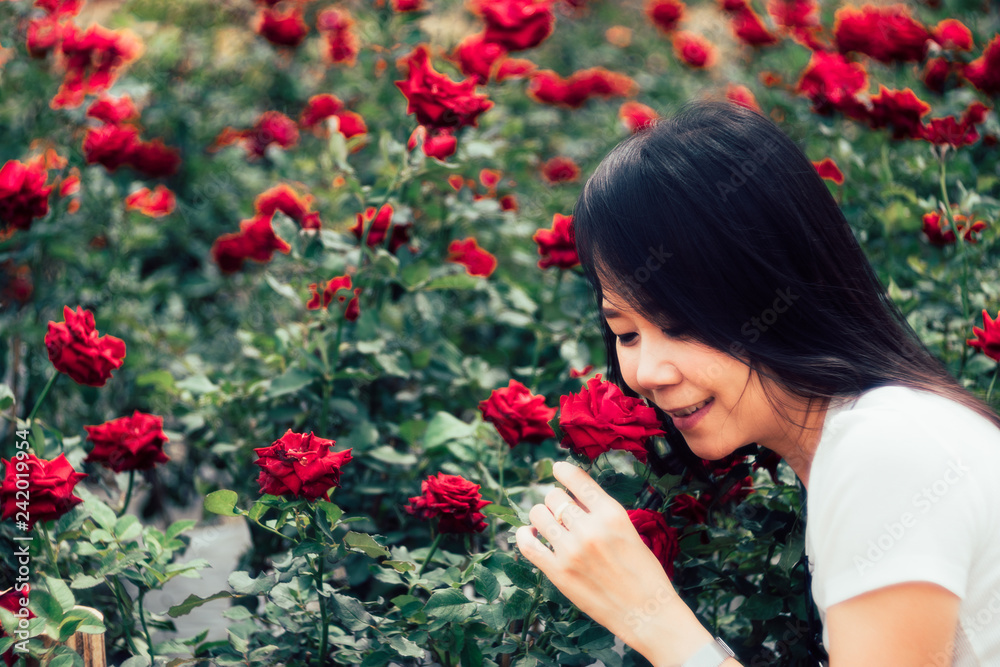 Beautiful smile asian woman in the rose field.Vintage Style