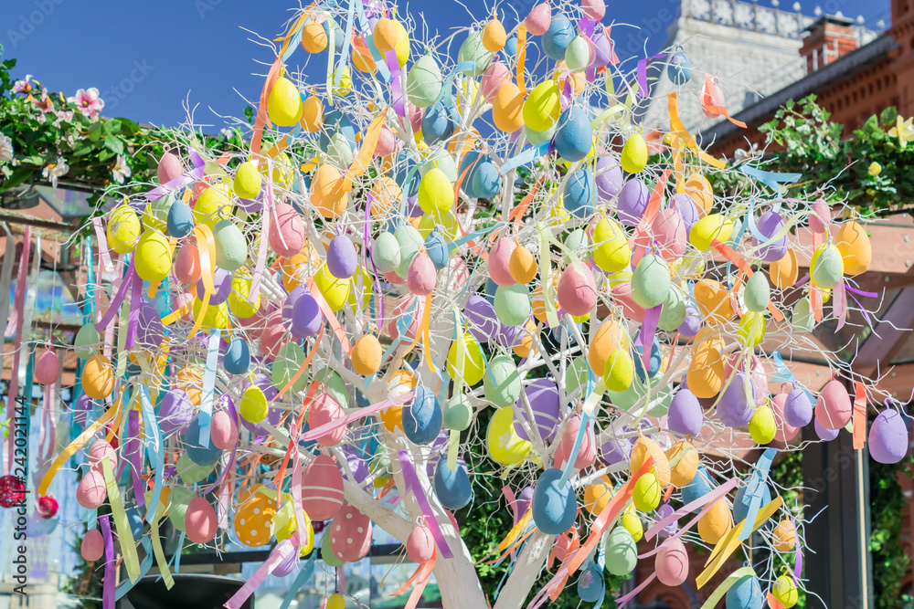 colorfull easter egg tree. brights eggs hanging from branches.