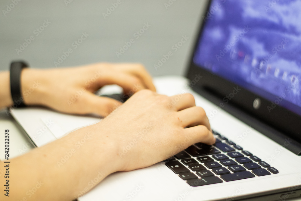 Man using laptop, searching web, browsing information, having workplace at home Man using laptop, searching web, browsing information, having workplace at home