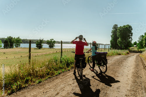 Man and woman riding bicycle on the lake and park