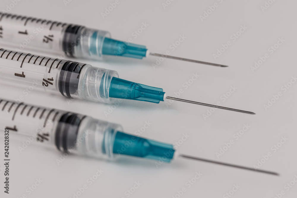Close up view of a three syringes with hypodermic needles. Opiate and heroin overdoses have skyrocketed in recent years V Close up view of a three syringes with hypodermic needles. Opiate and heroin overdoses have skyrocketed in recent years V