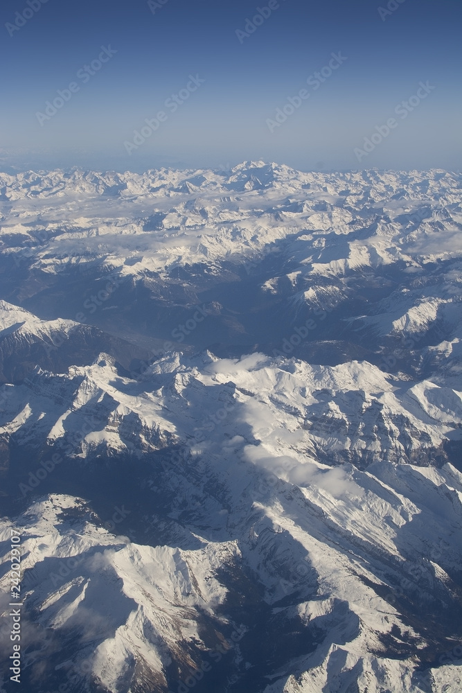 Fototapeta premium Swiss Alpes with snowy mountain tops aerial