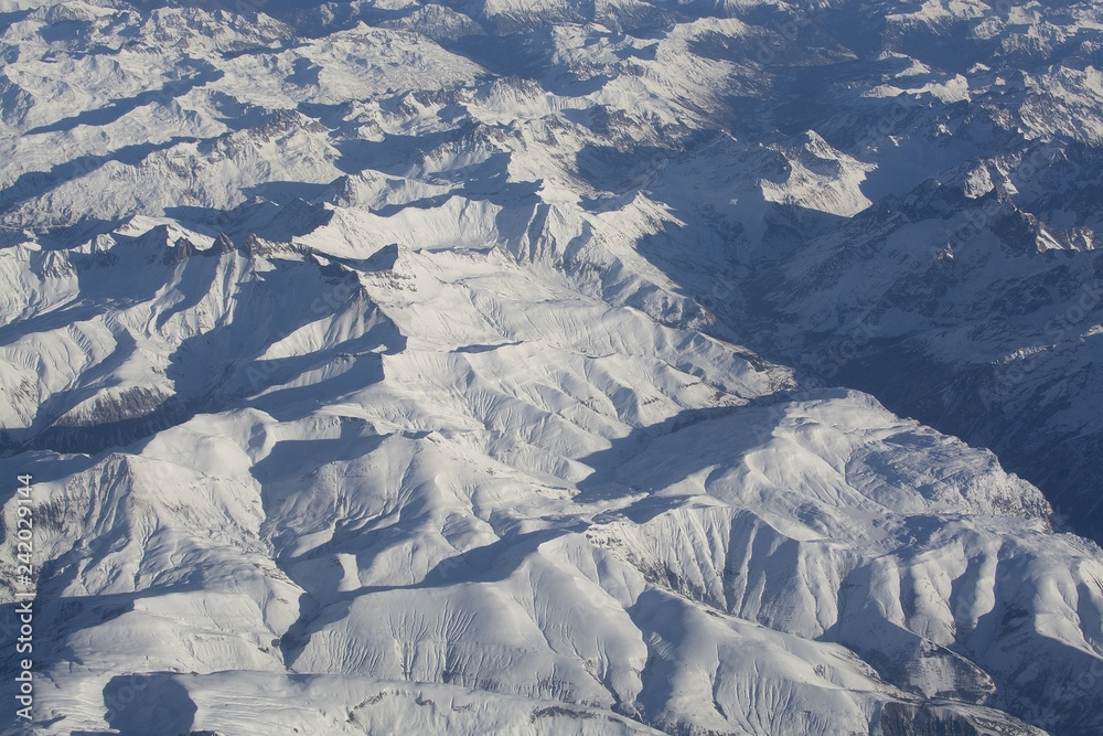 Fototapeta premium Swiss Alpes with snowy mountain tops aerial