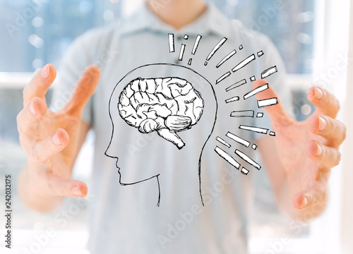Brain illustration with young man holding his hands
