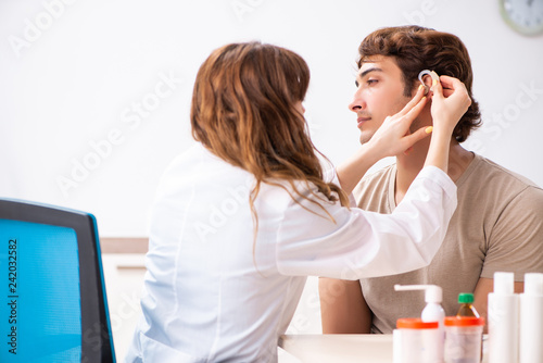 Patient with hearing problem visiting doctor otorhinolaryngologi photo