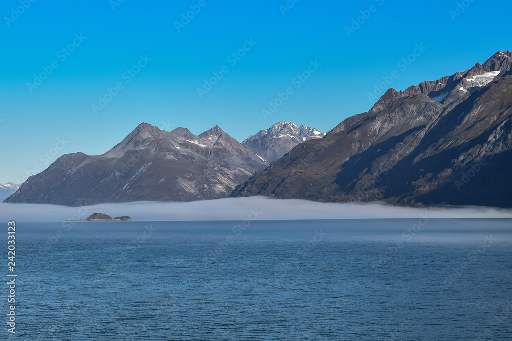 Snow covered mountains and clear skies in Glacier Bay, Alaska
