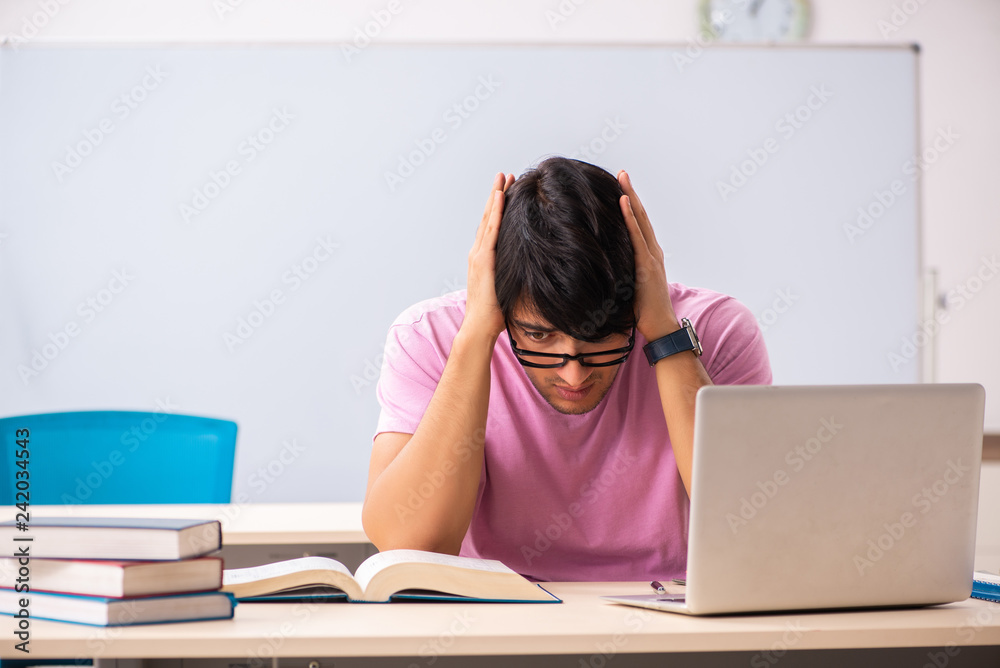 Young male student sitting in the class Young male student sitting in the class