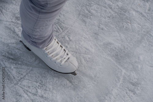 A white ice skating shoe from top on the ice