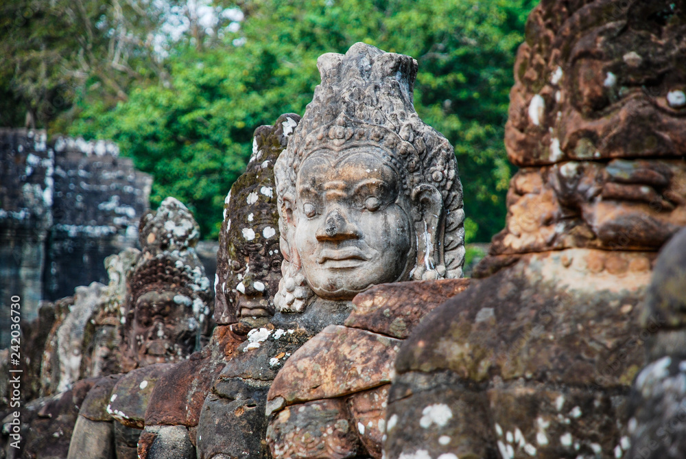 Intricately sculpted heads in the temples of Angkor Wat