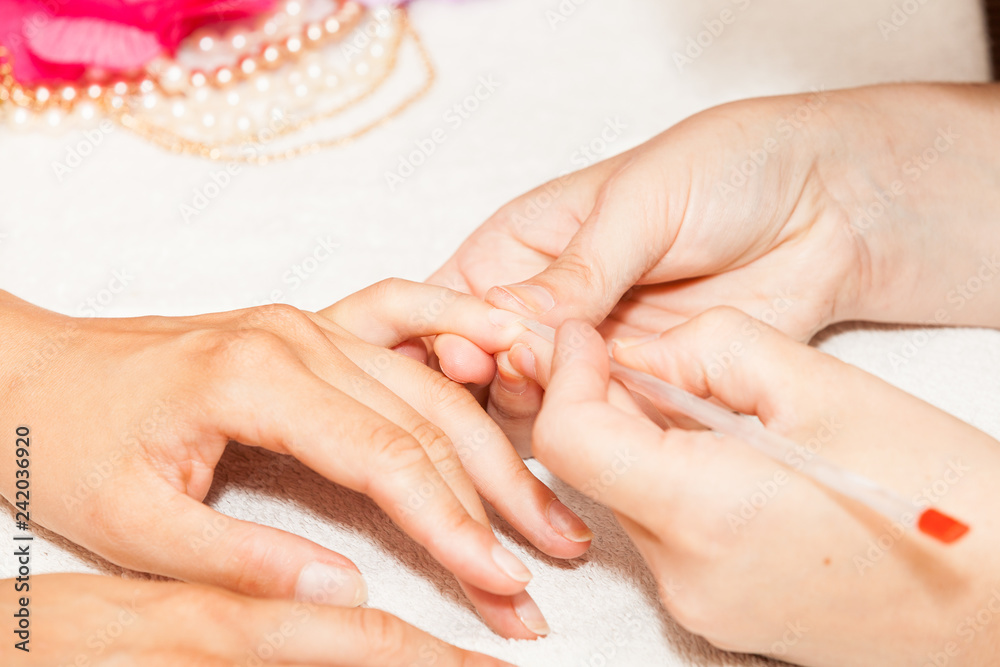 Naklejka premium Manicure of nails from a woman's hands before applying nail polish