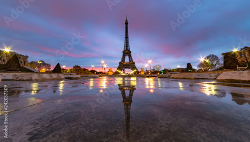 Sunrise on the Eiffel tower reflection on the Trocadero fountain water in Paris, one of the most visited building by the tourists