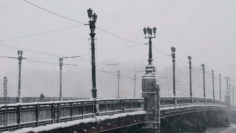 Winter bad weather, snowfall, snow-covered city bridge close up Winter bad weather, snowfall, snow-covered city bridge close up