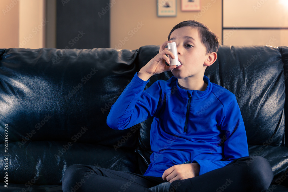 Fototapeta premium Boy holding asthma inhaler