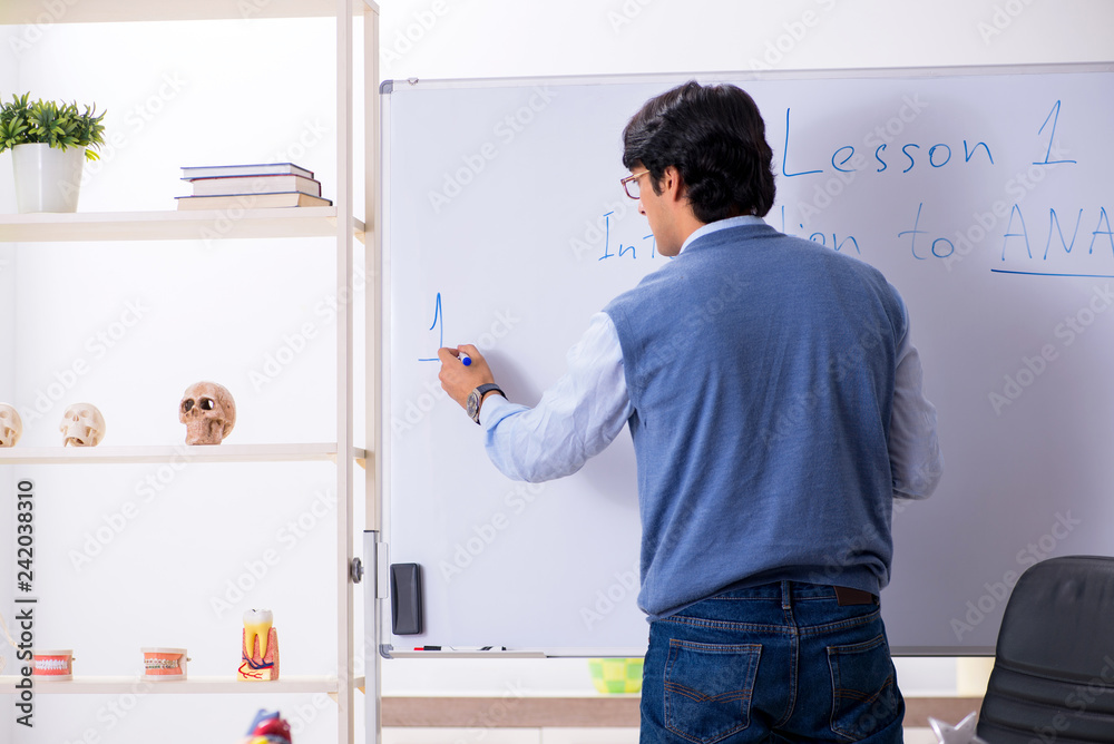 Young lecturer teacher teaching anatomy Young lecturer teacher teaching anatomy