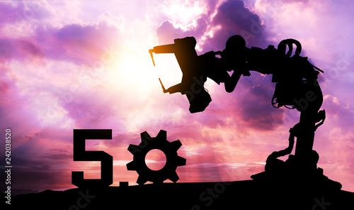 Silhouette of business man command automation robot arm machine technology , industry 5.0 , artificial intelligence trend concept. Sunrise twilight background.