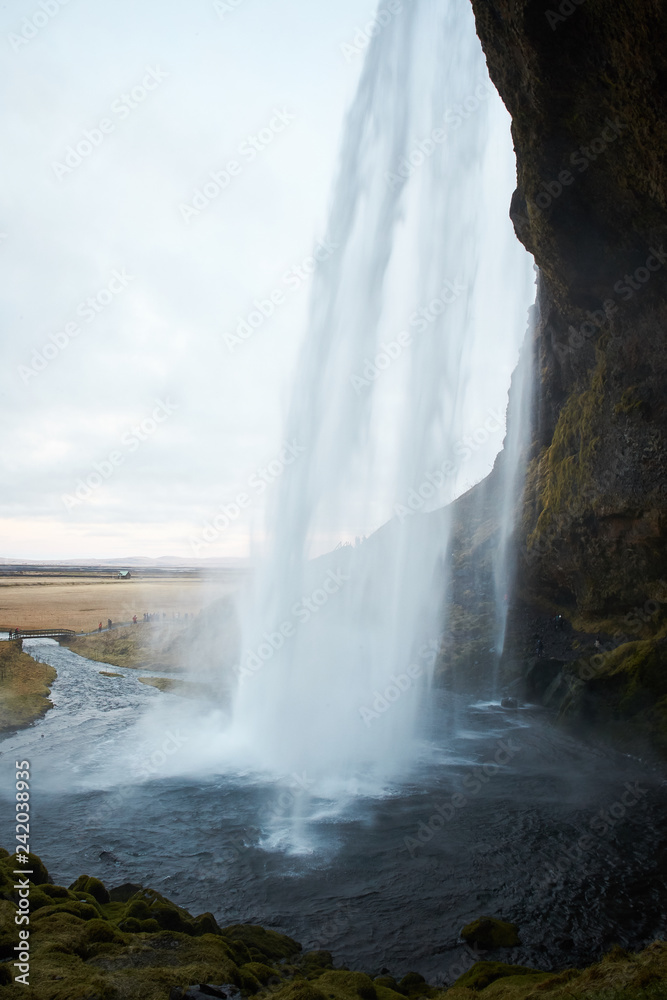 Seljalandsfoss - Seljalandsfoss is located in the South Region in Iceland right by Route 1. One of the interesting things about this waterfall is that visitors can walk behind it into a small cave.