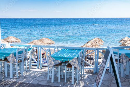 Fototapeta Naklejka Na Ścianę i Meble -  restaurant terrace in front of the beach in kamari on the island of santorini