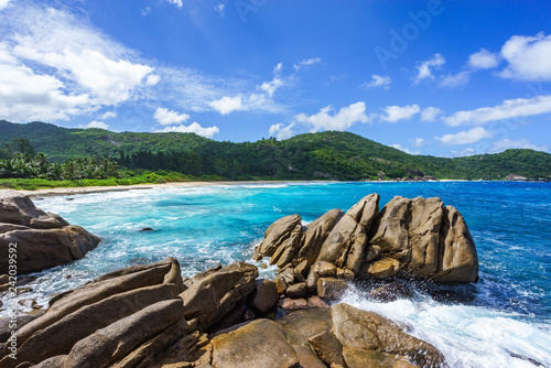 water fountain over granite rocks,wild tropical beach with palms, seychelles 7 © Christian B.