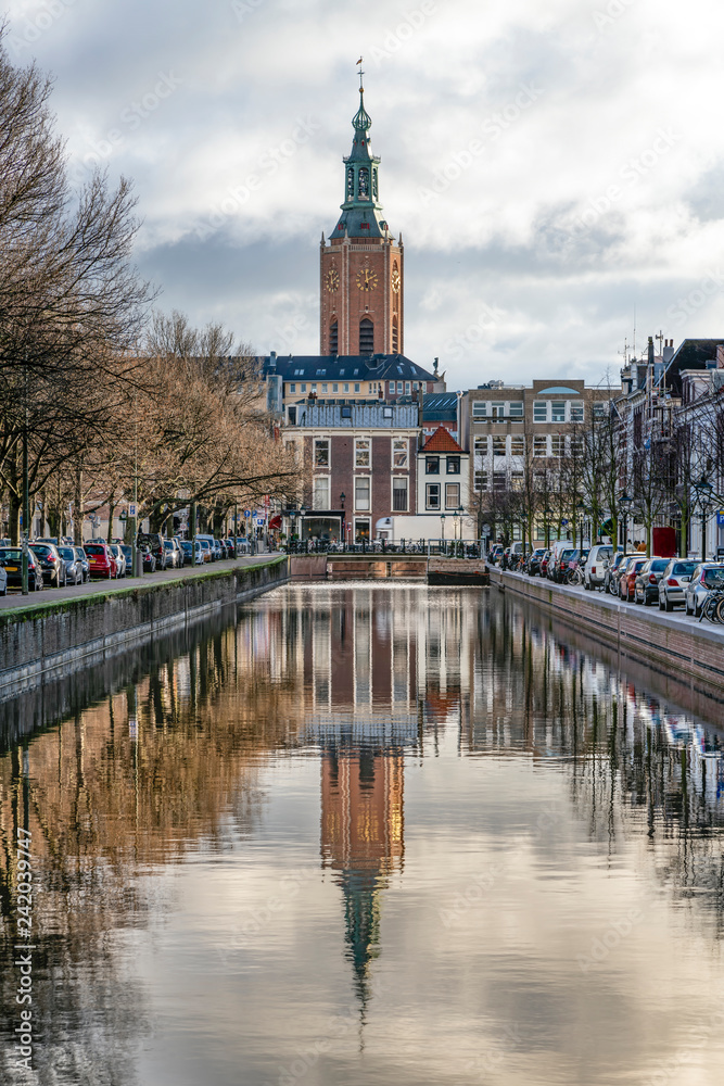 Saint James church reflected on the canal calm water nested to the royal stable, in The Hague