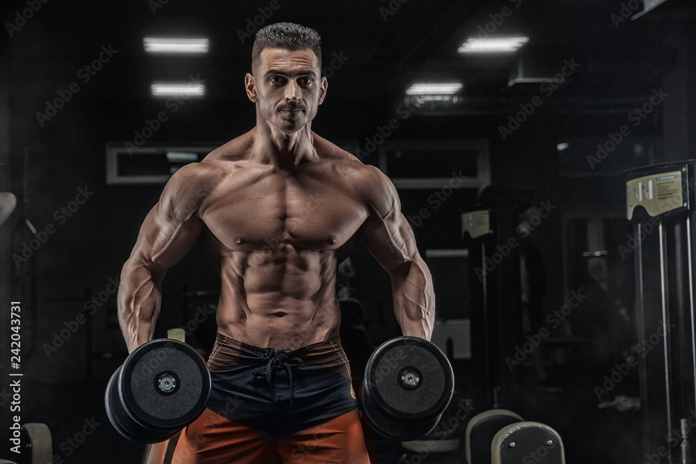 Young handsome sportsman bodybuilder weightlifter with an ideal body Young handsome sportsman bodybuilder weightlifter with an ideal body