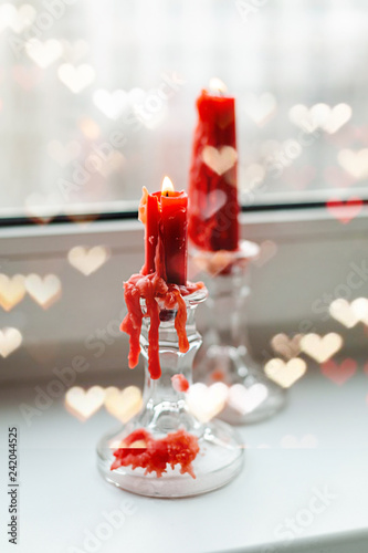 St. Valentine's red candles on the windowsill photo