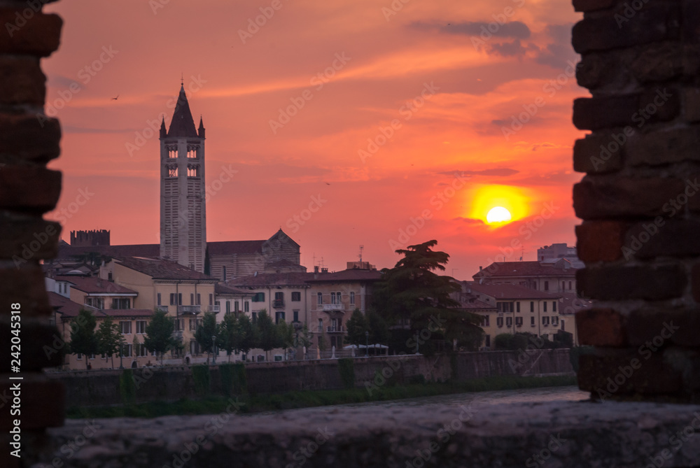 Verona, Italy. Basilica of San Zeno Maggiore seen from the Ponte della Pietra during the sunset.