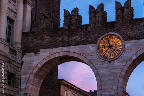 Verona, Italy. detail of Portoni della Brà during sunset. The battlements of the walls and the clock are clearly visible. The Portoni della Brà is a gate of Verona built along the medieval walls 