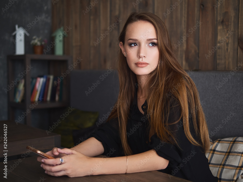 Beautiful woman reading good news on mobile phone during rest in coffee shop. Happy caucasian female watching photos on smartphone checking social networks while relaxing in cafe during free time Beautiful woman reading good news on mobile phone during rest in coffee shop. Happy caucasian female watching photos on smartphone checking social networks while relaxing in cafe during free time