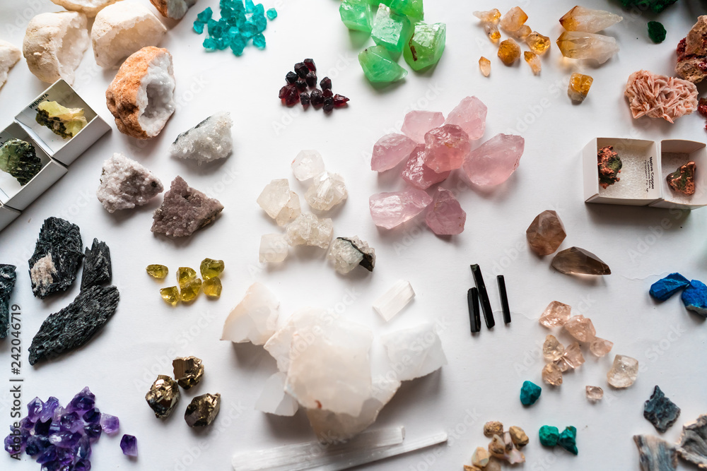 Collection of beautiful precious stones on white table.