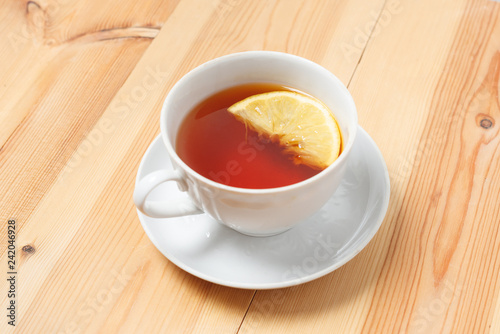 Cup of tea with lemon on the wooden table