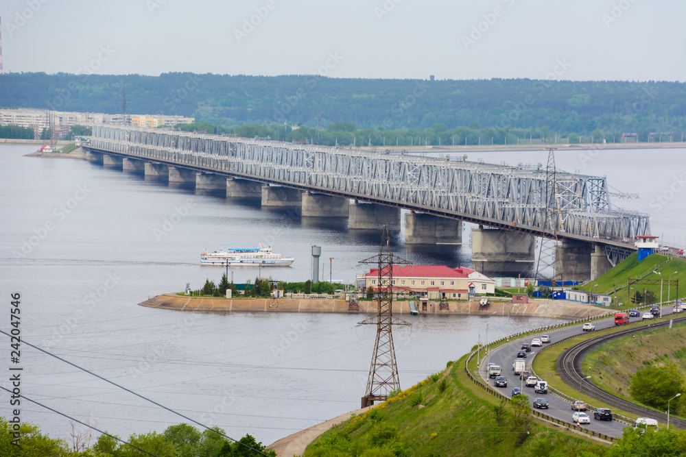 The Imperial Bridge across the Volga. A bridge across the Volga river in spring in Ulyanovsk, Russia. The view from the top of the embankment of the Volga in Ulyanovsk. The Imperial Bridge across the Volga. A bridge across the Volga river in spring in Ulyanovsk, Russia. The view from the top of the embankment of the Volga in Ulyanovsk.