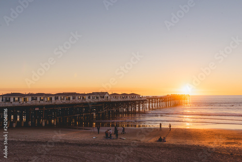 People doing activities at the beach near the pier with beautiful sunset. Pacific Beach in San Diego  California