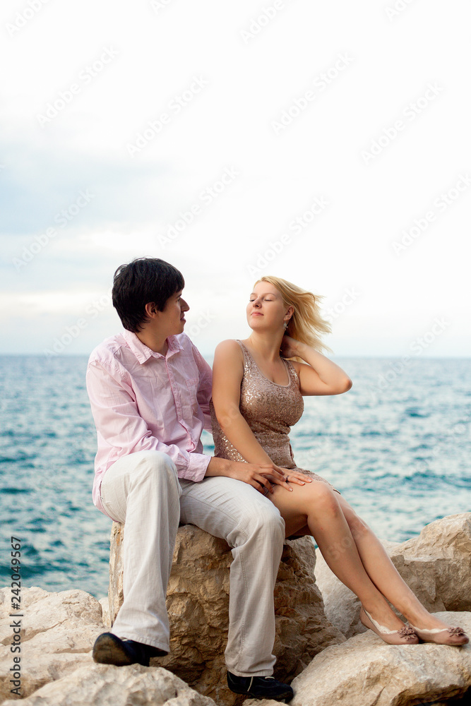Young sexy blonde woman and man at romantic date at vacation.