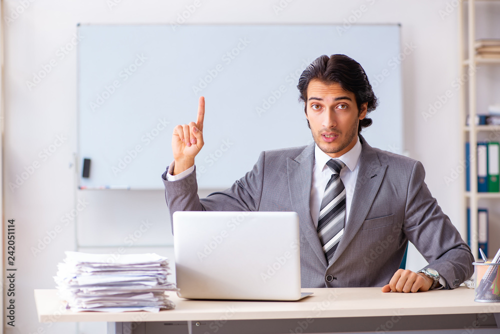 Young handsome businessman employee in the office Young handsome businessman employee in the office