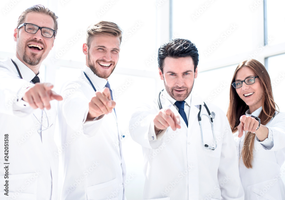 group of doctors pointing their finger at you group of doctors pointing their finger at you