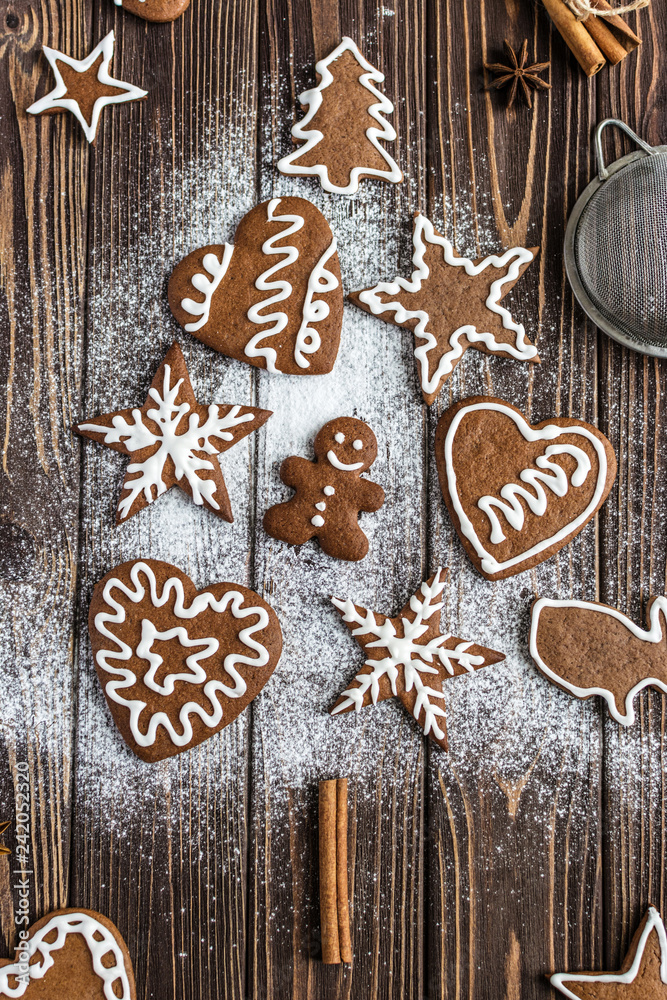 Christmas tree made from gingerbread cookies on a wooden background. New year and christmas postcard Christmas tree made from gingerbread cookies on a wooden background. New year and christmas postcard