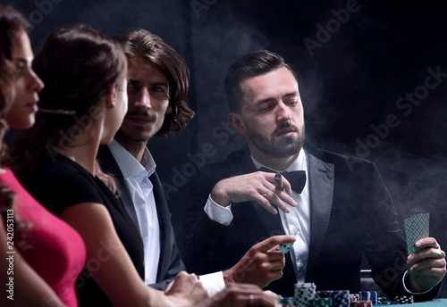 Upper class friends gambling in a casino