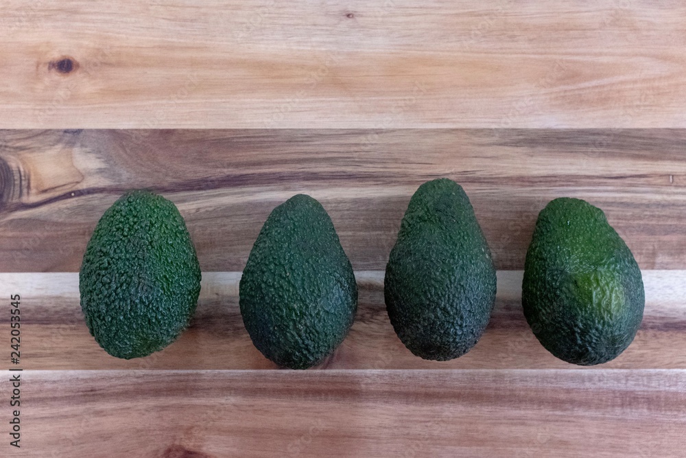 Avocado pears on a wooden chopping board