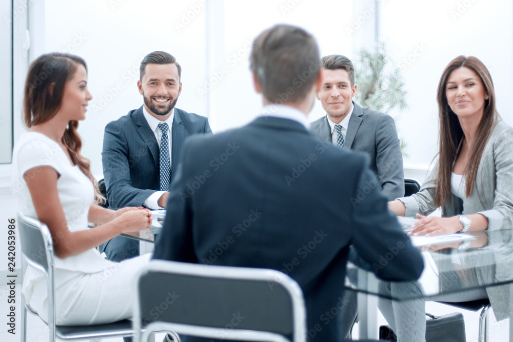 group of business people sitting at a table at an office working meeting group of business people sitting at a table at an office working meeting