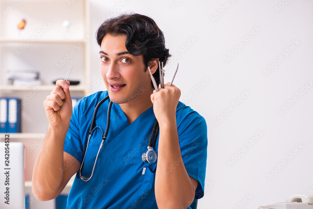 Young handsome doctor working at the clinic Young handsome doctor working at the clinic