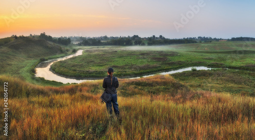 girl looks at the picturesque river. tourist over the river. picturesque autumn morning