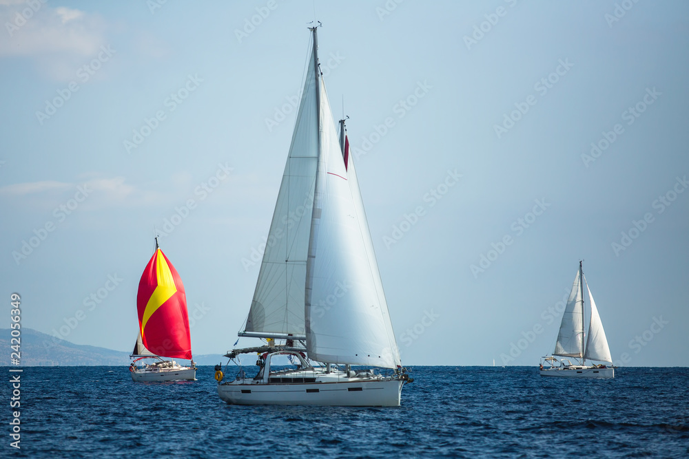 Sailing boats participate in sail yacht regatta in the Aegean Sea.