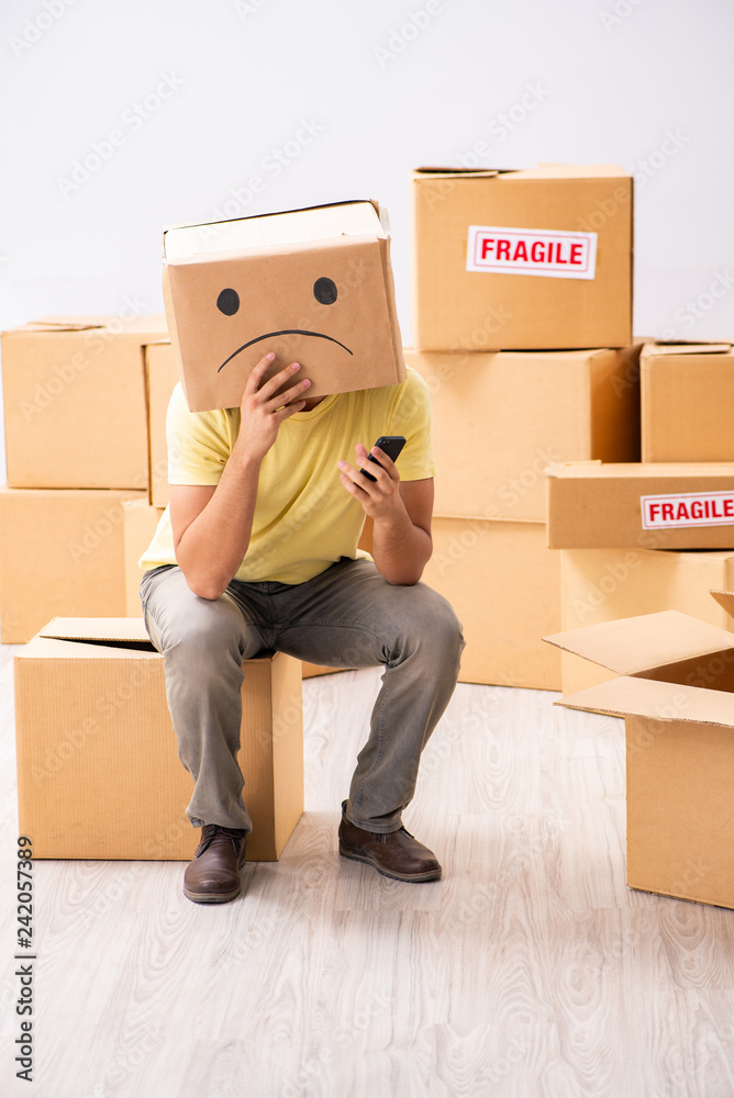 Unhappy man with box instead of his head Unhappy man with box instead of his head